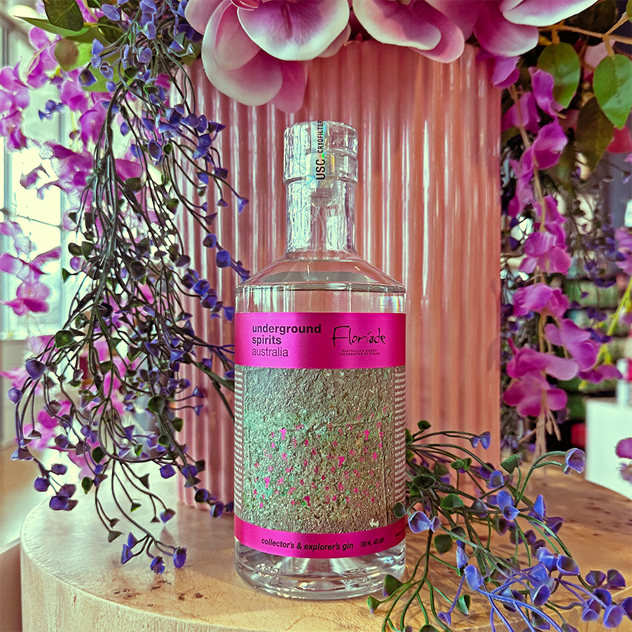 Collector’s & Explorer’s Floriade Gin 2025 bottle surrounded by vibrant spring flowers in Canberra
