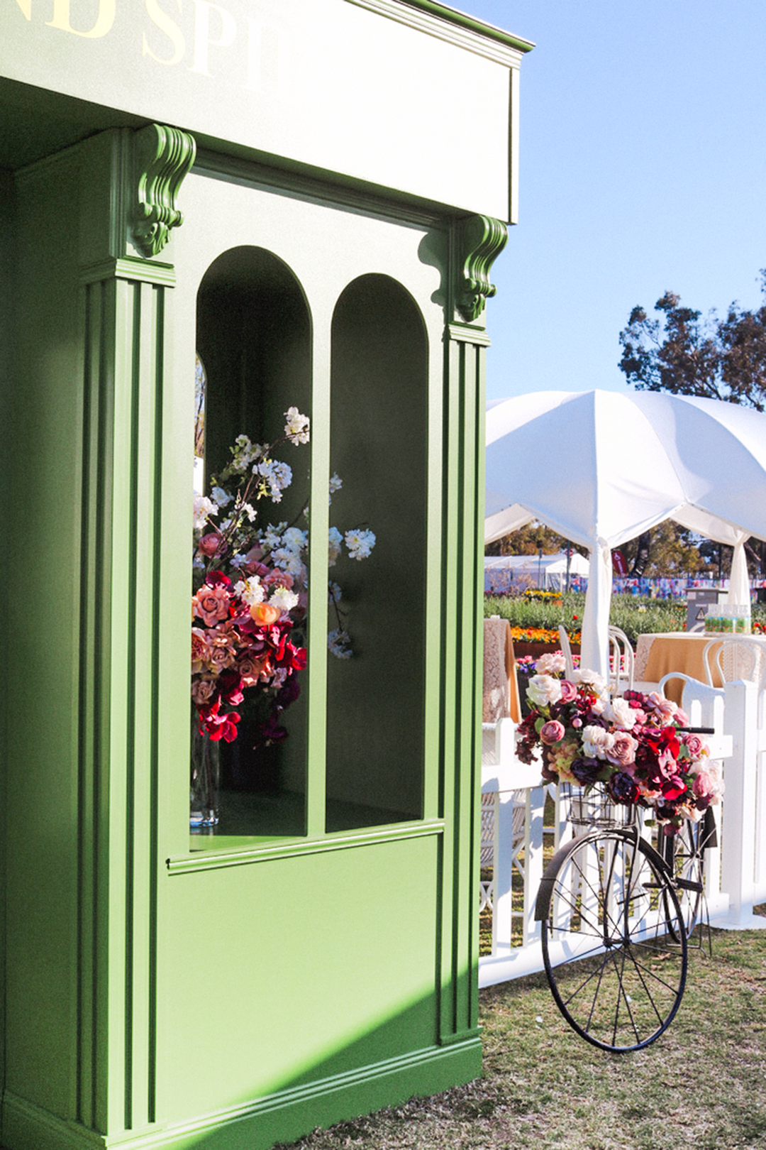 Underground Spirits entry at Floriade with floral arrangements and a bicycle, springtime sunshine and flowers