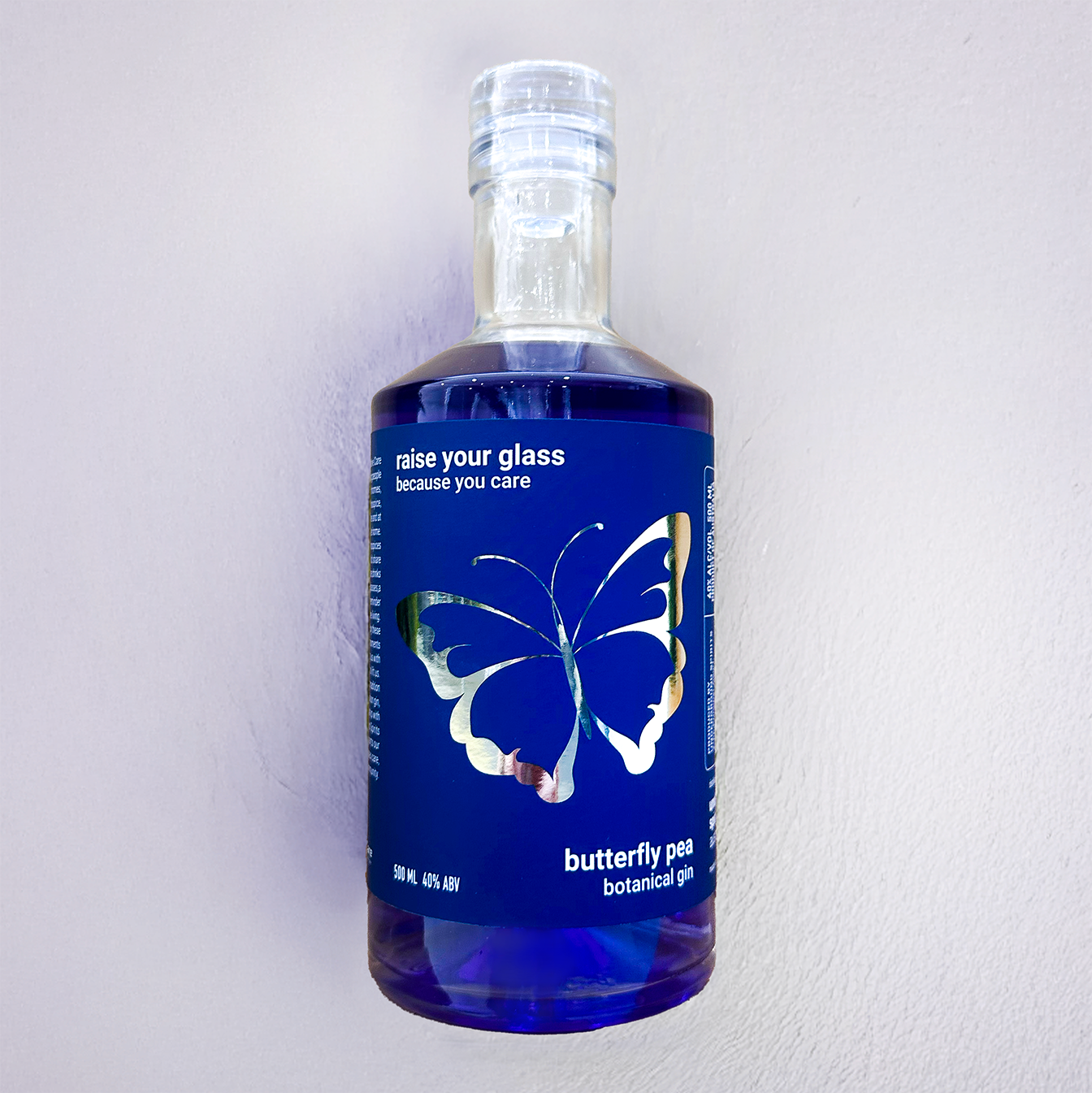 Underground Spirits  Palliative Care ACT 40th Anniversary Gin bottle featuring butterfly design with deep blue butterfly pea