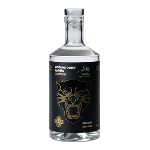 Image of a clear bottle filled with transparent vodka, featuring a striking black label with the face of a panther depicted in bold detail. The label commemorates The Panthers' consecutive victories in 2021, 2022, and 2023, celebrating their triple championship. The bottle exemplifies a sleek and modern design, tailored for collectors and sports enthusiasts